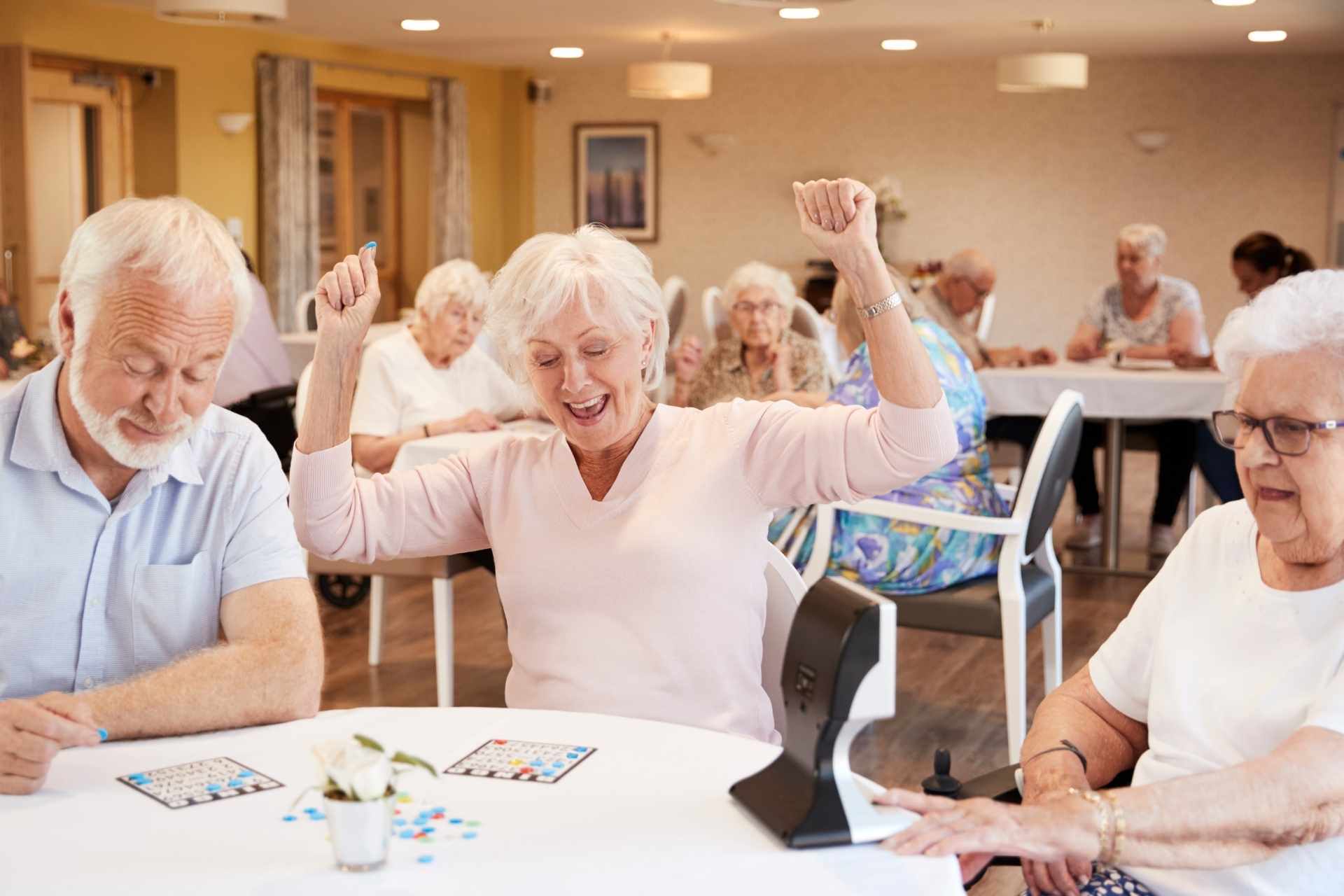Senior woman winning bingo in a retirement community