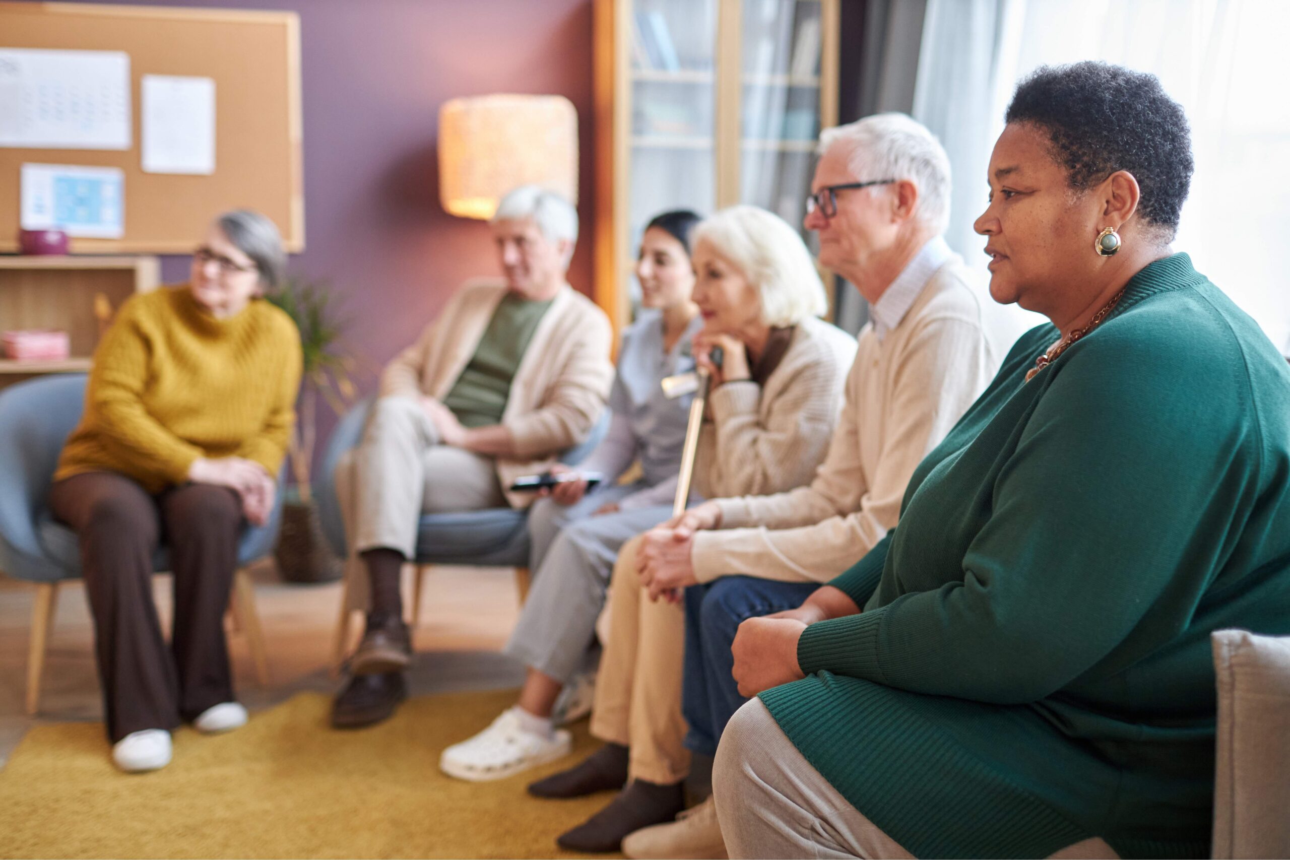 elderly-people-sitting-in-row-together-scaled-1