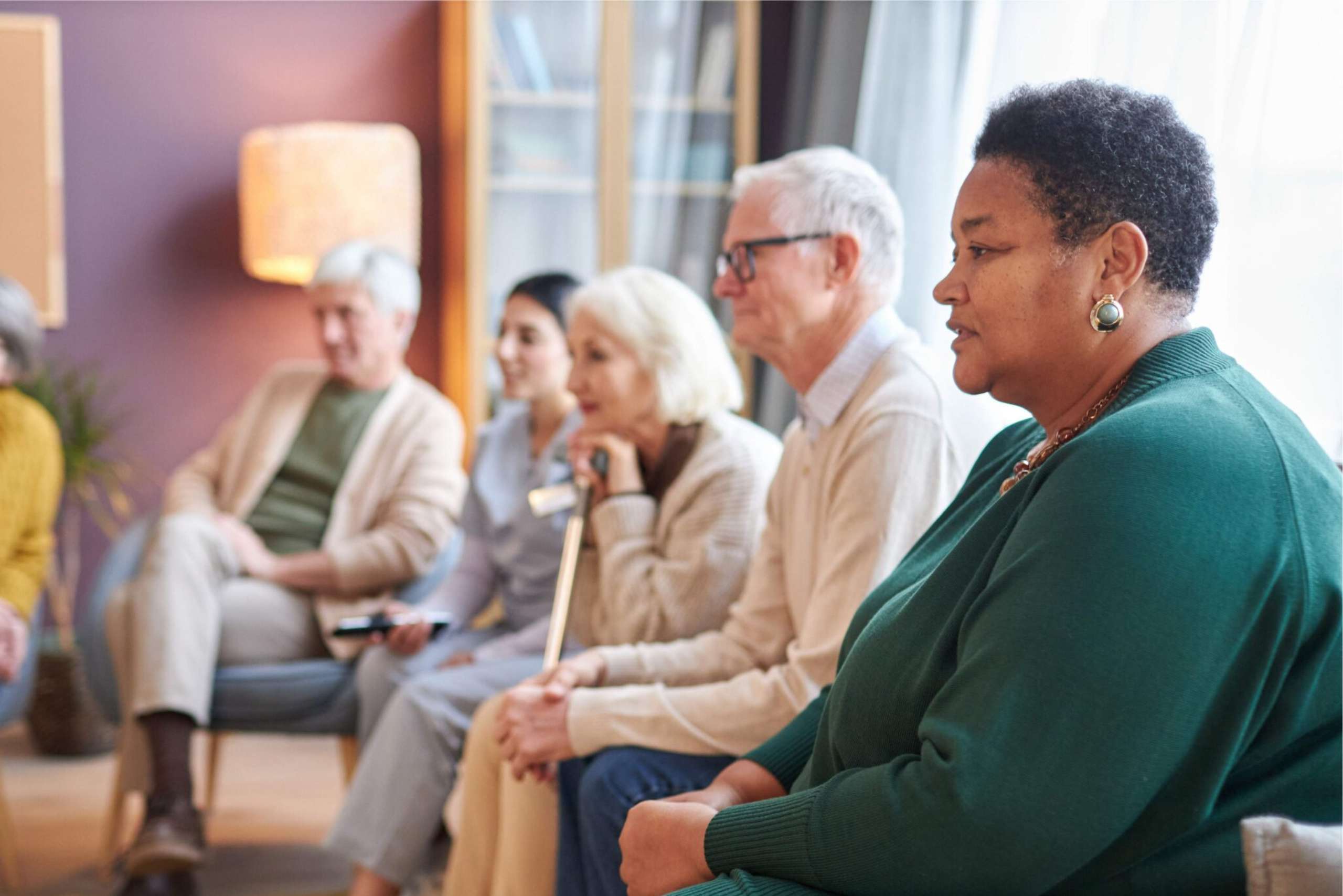 A group of seniors sitting on a couch together